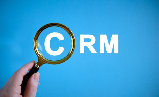 crm text with magnifying glass blue background 126791 262